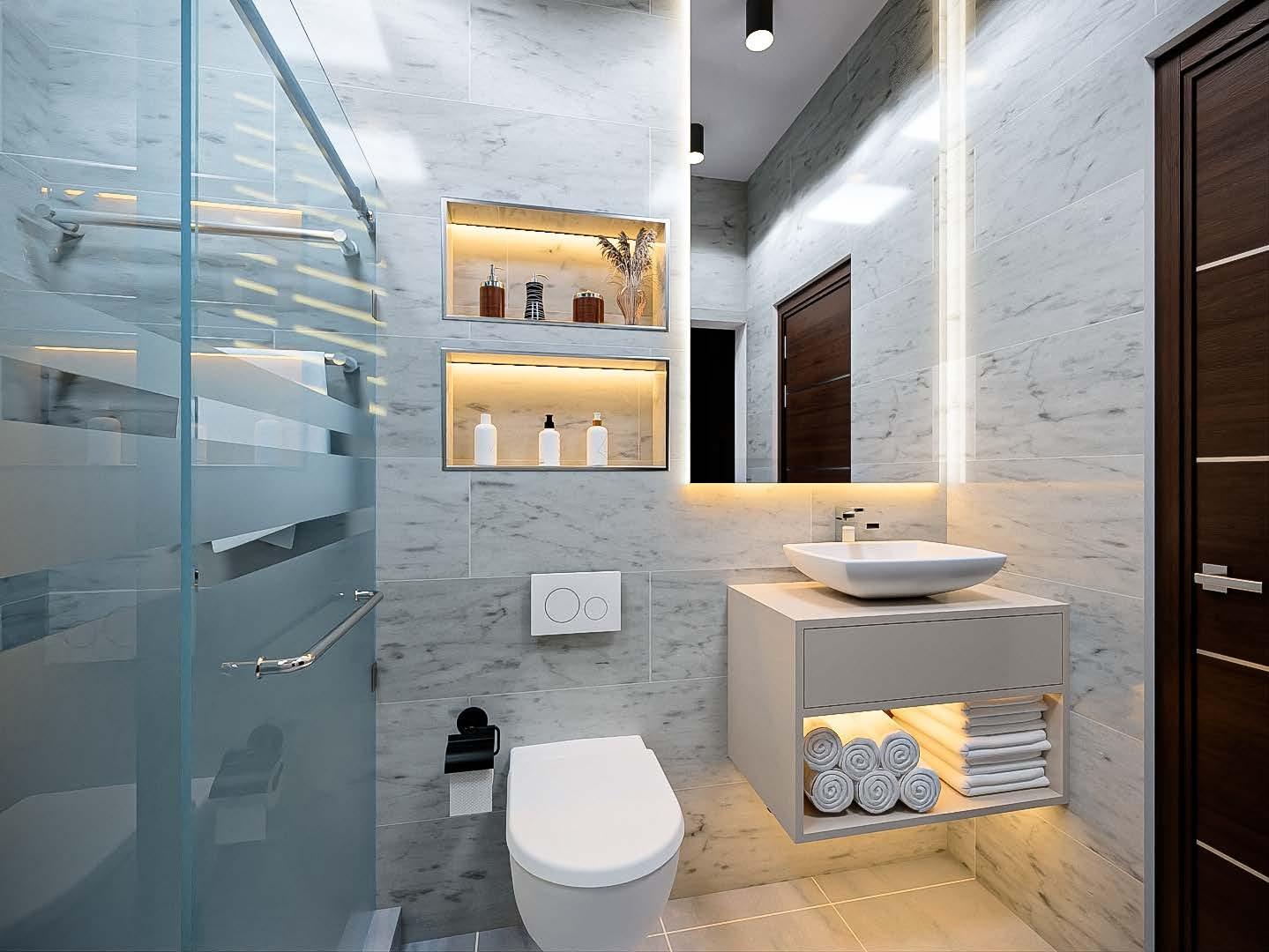 Marble bathroom with a floating vanity, backlit mirror and lit shelving niches