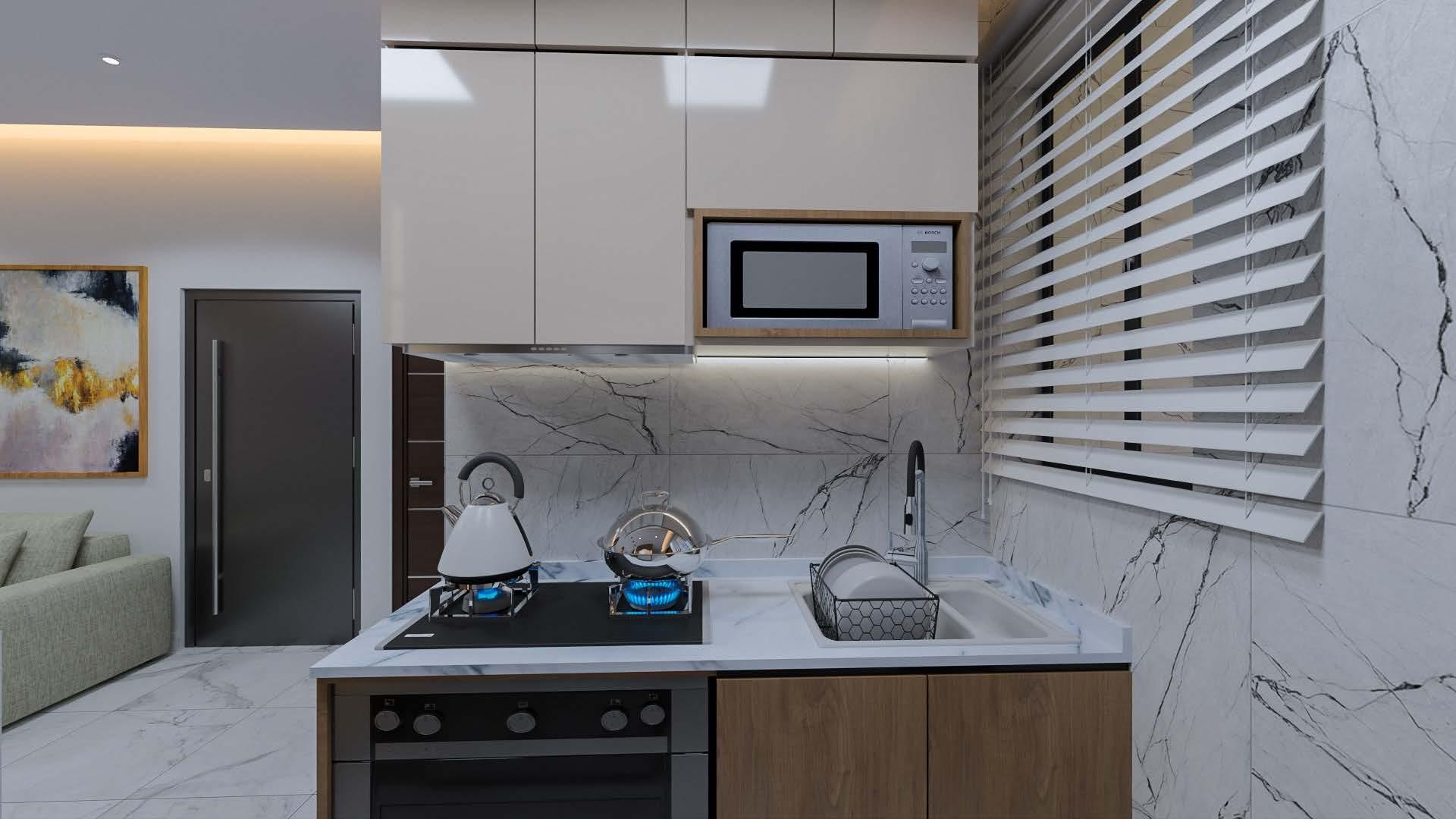 Kitchen with a veined marble splashback, gas hob and built-in microwave