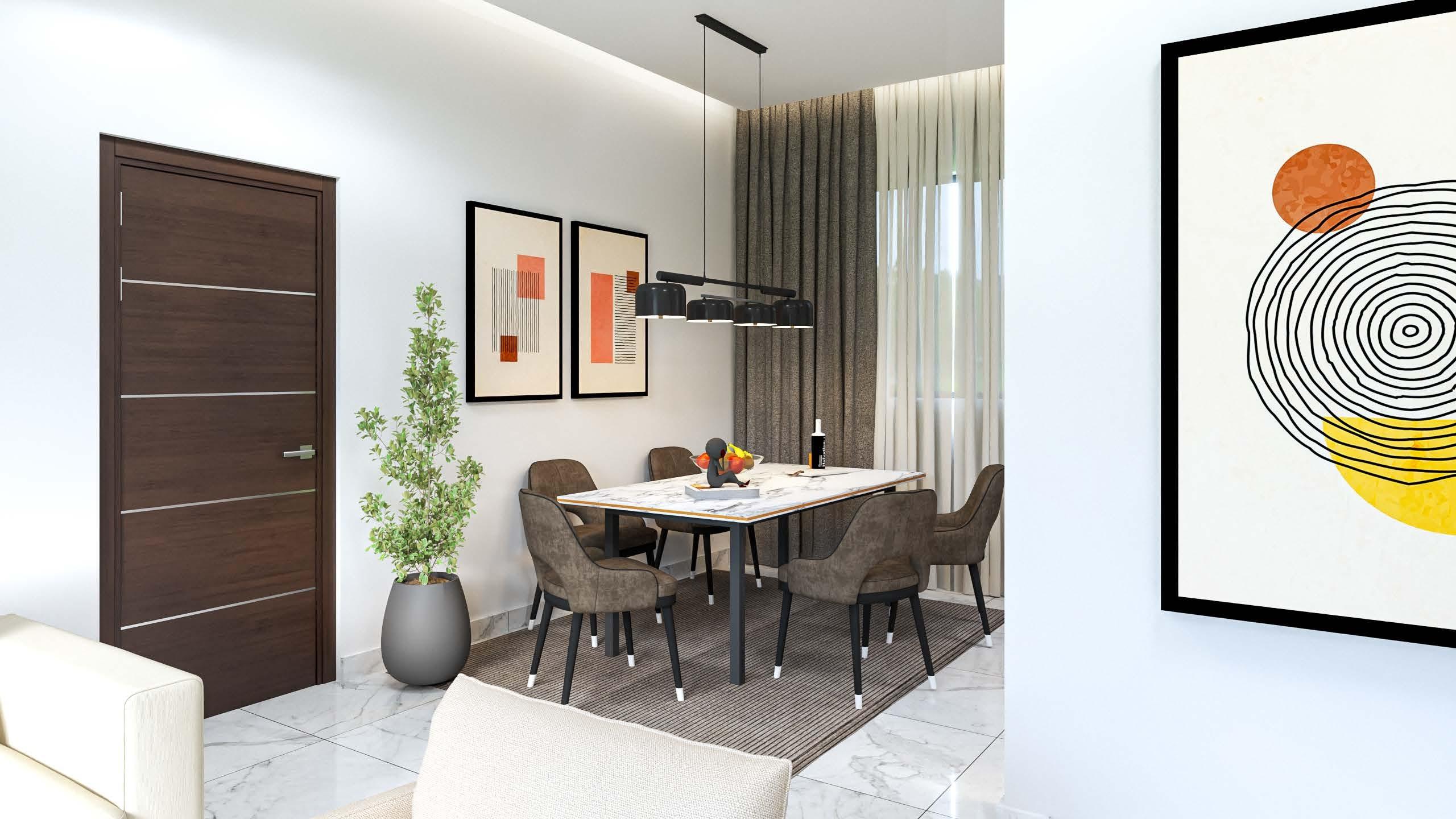 Dining table beneath a linear pendant light, with framed prints on the wall